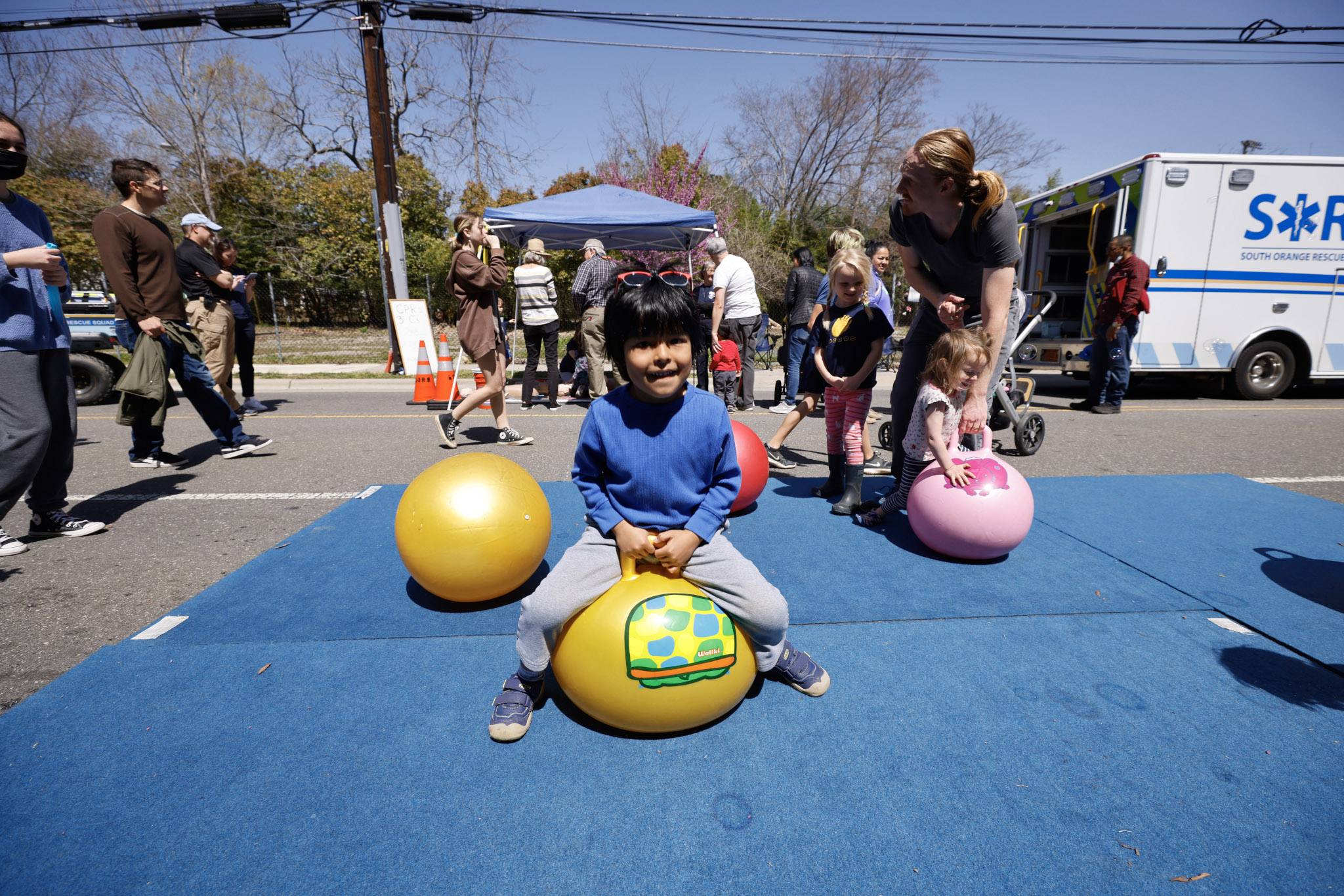 Kid on bouncy ball Open Streets