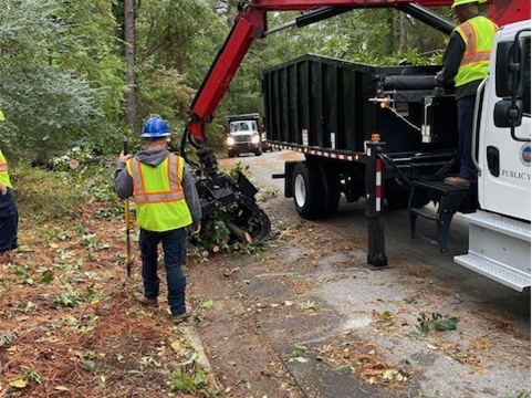 Picture shows solid waste Boom Truck collecting storm debris